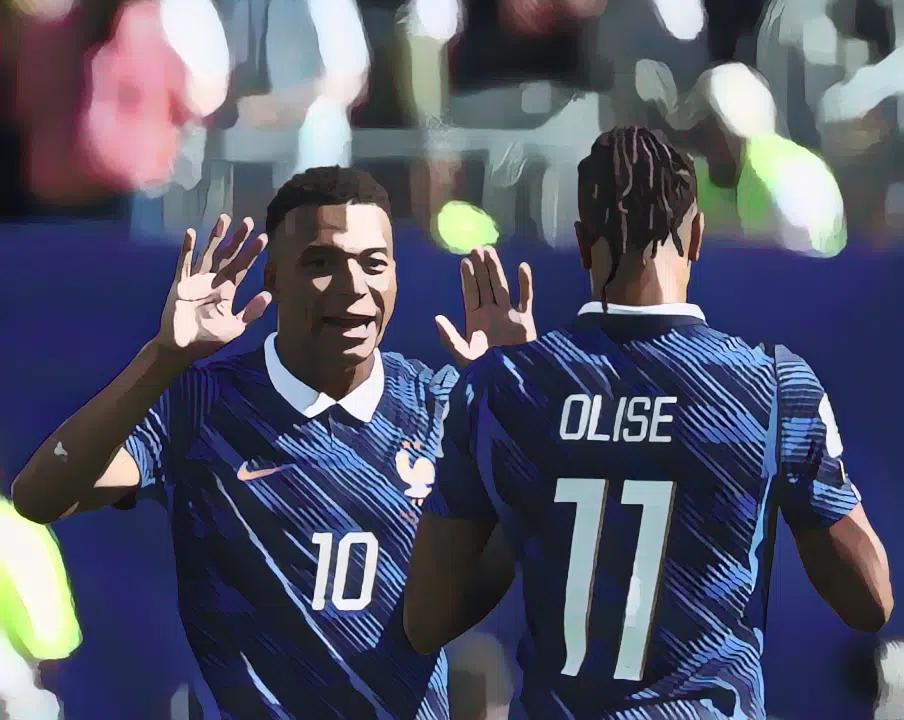 Kylian Mbappé celebrates with Michael Olise after scoring his team's first goal against Senegal.